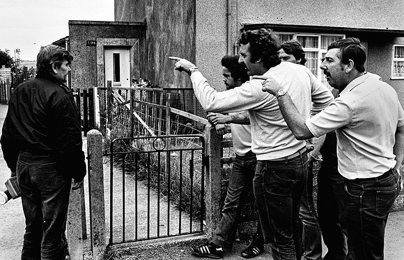 4. Protestors (right) confront a strikebreaker arriving home from his shift. August 1984