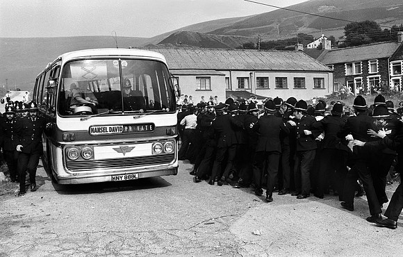 Police clear a path for a bus carrying strikebreaker Monty Morgan. August 1984