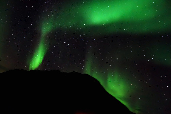 The Northern Lights, Aurora Borealis from the deck of Hurtigruten's Kong Harald sailing through fjords near Tromso