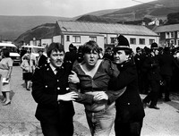 Police restrain young miner Darren Wood during protests against a strikebreaker. Blaengarw 1984.