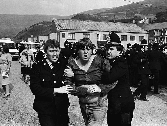 Police restrain young miner Darren Wood during protests against a strikebreaker. Blaengarw 1984.